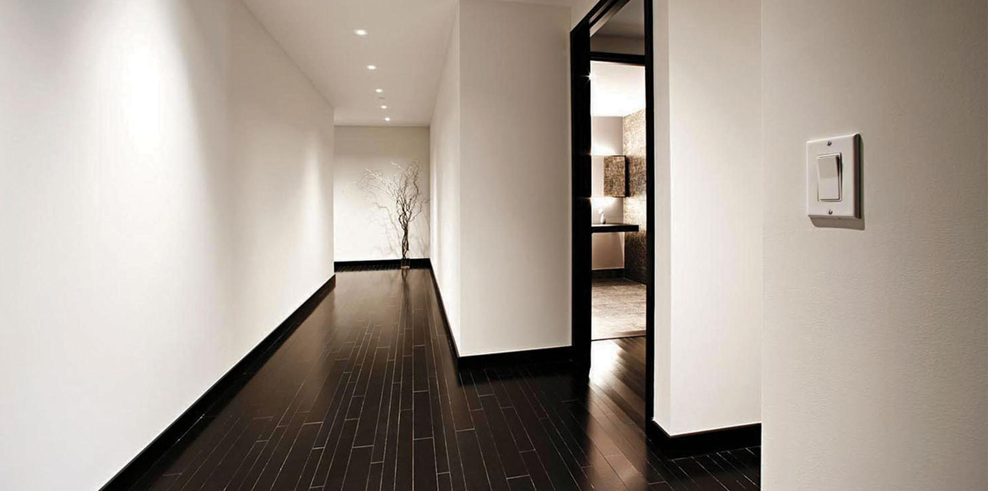 hallway with white walls and dark hardwood floors inside 20松 Street